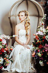 Image showing beauty young bride alone in luxury vintage interior with a lot of flowers close up