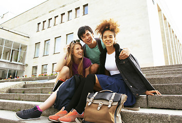 Image showing cute group of teenages at the building of university with books 