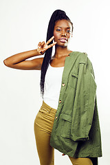 Image showing young pretty african-american girl posing cheerful emotional on white background isolated, lifestyle people concept