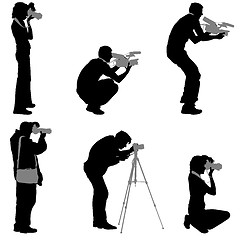 Image showing Set cameraman with video camera. Silhouettes on white background. illustration