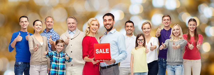 Image showing happy people with sale sign showing thumbs up