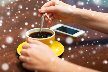 Image showing close up of woman with smartphone and coffee