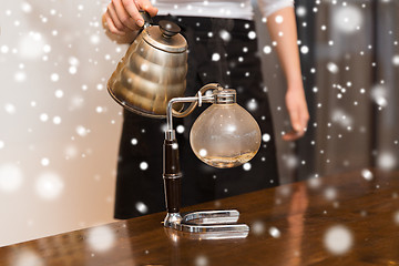 Image showing close up of woman with siphon coffee maker and pot