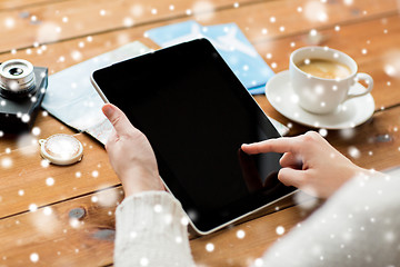 Image showing close up of traveler hands with tablet pc and map