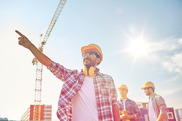 Image showing builders pointing finger aside on construction