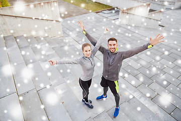 Image showing happy couple of sportsmen outdoors on city street