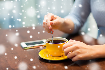 Image showing close up of woman with smartphone and coffee