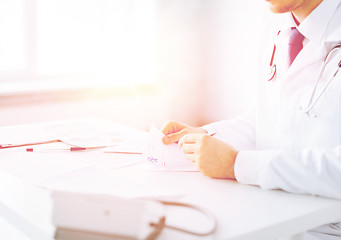 Image showing male doctor writing prescription paper