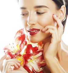 Image showing young pretty brunette woman with red flower amaryllis close up i