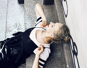 Image showing young pretty party girl smiling covered with glitter tinsel, fas