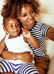 Image showing adorable sweet young afro-american mother with cute little daughter, hanging at home, having fun playing smiling, lifestyle people concept, happy smiling modern family