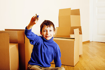 Image showing little cute boy in empty room, remoove to new house. home alone, lifestyle people concept