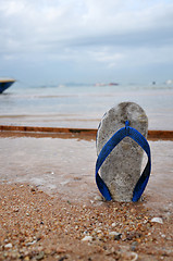 Image showing Beach slippers on a sandy beach