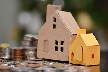 Image showing Paper house and stacks of coins standing