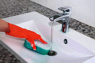 Image showing hand of woman in glove washes sink