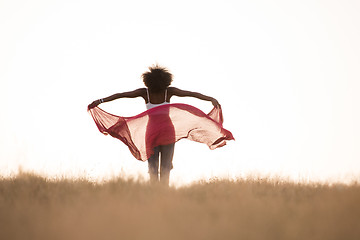 Image showing black girl dances outdoors in a meadow