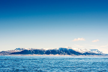 Image showing Snow on mountains in the blue ocean