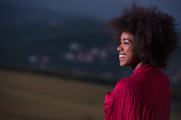 Image showing outdoor portrait of a black woman with a scarf