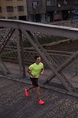 Image showing a young man jogging in the city