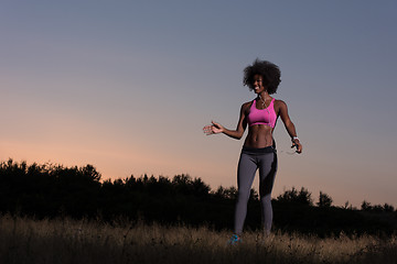 Image showing black woman is doing stretching exercise relaxing and warm up