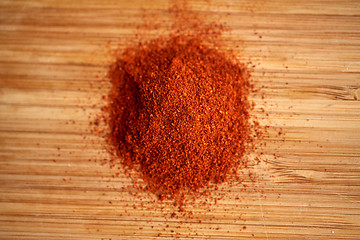 Image showing cayenne pepper or paprika powder on wood