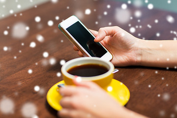 Image showing woman with smartphone drinking coffee at cafe