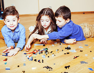 Image showing funny cute children playing lego at home, boys and girl smiling, first education role lifestyle