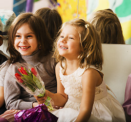 Image showing three little diverse girls at birthday party having fun