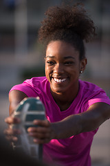 Image showing African American woman doing warming up and stretching