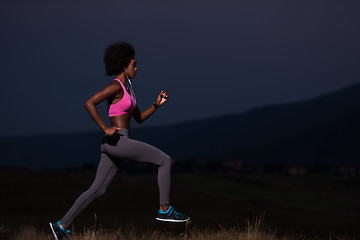 Image showing Young African american woman jogging in nature