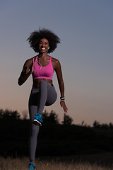 Image showing black woman is doing stretching exercise relaxing and warm up