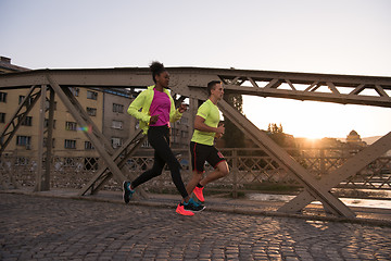 Image showing young multiethnic couple jogging in the city