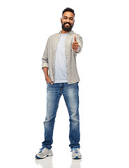 Image showing happy indian man showing thumbs up over white