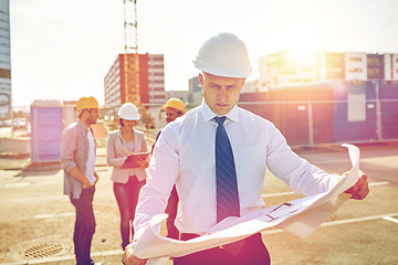 Image showing architect with blueprint on construction site