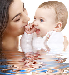 Image showing bathing baby in mother hands