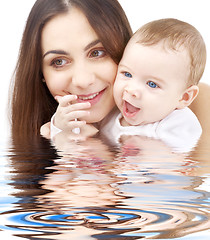 Image showing bathing baby in mother hands