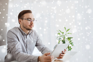 Image showing creative male worker with tablet pc at home office