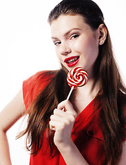 Image showing young pretty brunette girl with red candy posing on white background isolated