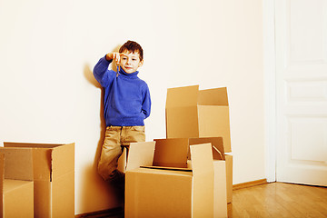 Image showing little cute boy in empty room, remoove to new house. home alone, lifestyle people concept