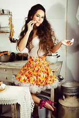 Image showing crazy real woman housewife on kitchen, eating perfoming, bizare 