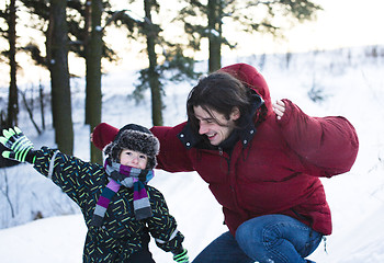 Image showing young happy father with his son little cute boy outside in winter park, lifestyle people concept