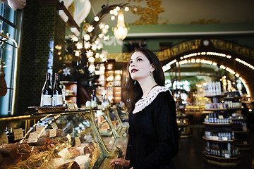 Image showing young elegant brunette woman in cafe drinking coffee, luxury int