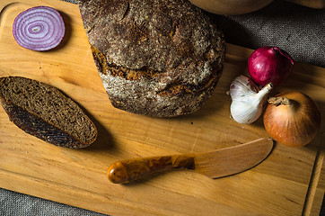 Image showing Top view on homemade bread and onions