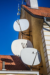 Image showing Satellite dish on the roof of an old building