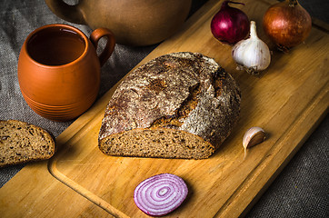 Image showing Still life with homemade bread and pottery