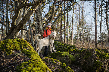 Image showing Woman with a white dog in the woods