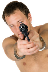 Image showing The young man with a pistol. Isolated