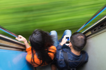 Image showing Couple traveling by train. Motion blured image creating impression of movement and speed.