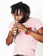 Image showing young handsome african american boy singing emotional with microphone isolated on white background, in motion gesturing smiling, lifestyle people concept