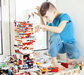 Image showing little cute preschooler boy playing lego toys at home happy smiling, lifestyle children concept